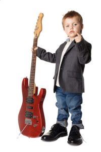 Toddler holding a guitar
