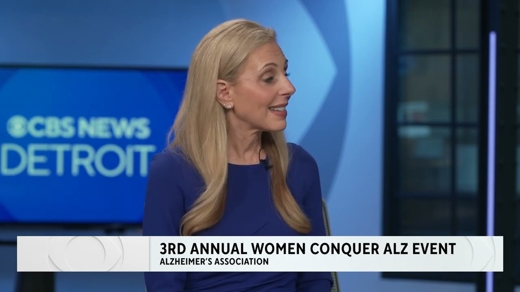 A blonde woman in a blue top speaks on CBS News Detroit. A graphic reads: "3RD ANNUAL WOMEN CONQUER ALZ EVENT" and "ALZHEIMER'S ASSOCIATION."