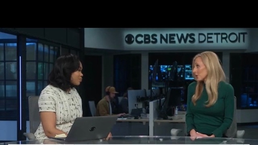 Two women on a CBS News Detroit set discuss "THE TALK YOU SHOULD HAVE WITH YOUR PARENTS." One woman in green speaks while the other in a patterned top listens with a laptop.